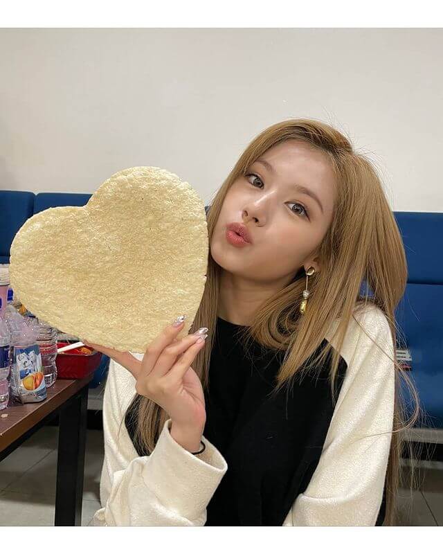 Sana sosteniendo una tortilla de forma de corazón mientras tira un beso